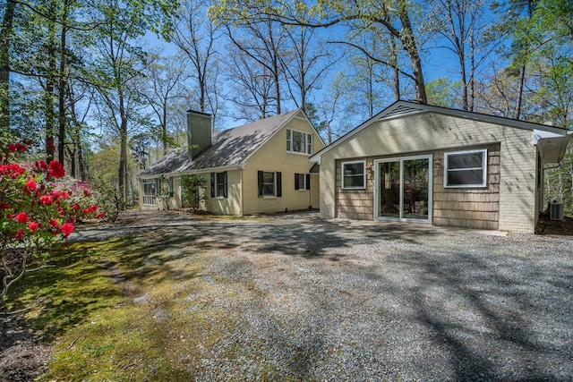 back of property featuring central AC