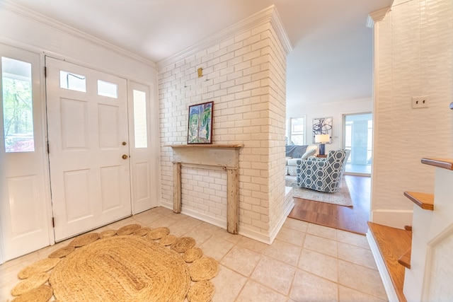 entryway with crown molding and light tile patterned flooring