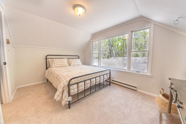 carpeted bedroom with baseboard heating, multiple windows, and vaulted ceiling