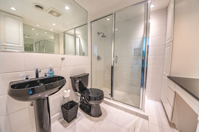 1032 Fishing Bay Rd, Deltaville, VA 23043 - bathroom with tile walls, a shower stall, tile patterned flooring, and recessed lighting