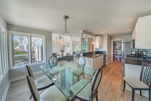 1032 Fishing Bay Rd, Deltaville, VA 23043 - dining space with light wood-style flooring, a chandelier, and recessed lighting