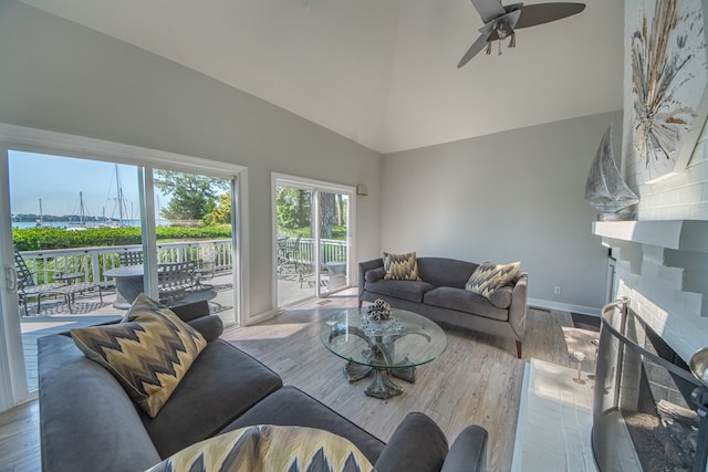 1032 Fishing Bay Rd, Deltaville, VA 23043 - living area featuring wood finished floors, high vaulted ceiling, ceiling fan, and a fireplace