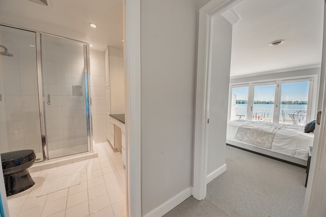 1032 Fishing Bay Rd, Deltaville, VA 23043 - ensuite bathroom with a water view, a stall shower, recessed lighting, and tile patterned floors