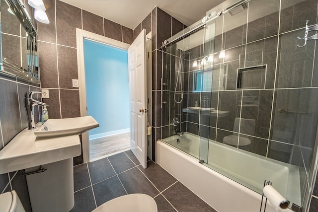 1032 Fishing Bay Rd, Deltaville, VA 23043 - bathroom with combined bath / shower with glass door, tile walls, and tile patterned floors