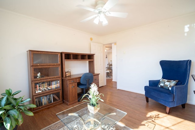 home office featuring baseboards, wood finished floors, a ceiling fan, and ornamental molding