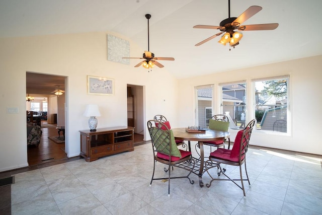 dining space with a chandelier, high vaulted ceiling, and light tile patterned flooring