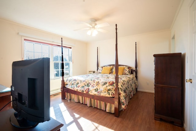 bedroom featuring ceiling fan, visible vents, wood finished floors, and ornamental molding