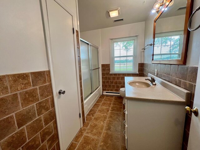 2048 Lake Rd, Lottsburg, VA 22511 - bathroom with tile walls, wainscoting, a baseboard radiator, vanity, and toilet