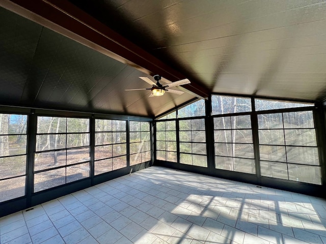 unfurnished sunroom with vaulted ceiling with beams and ceiling fan