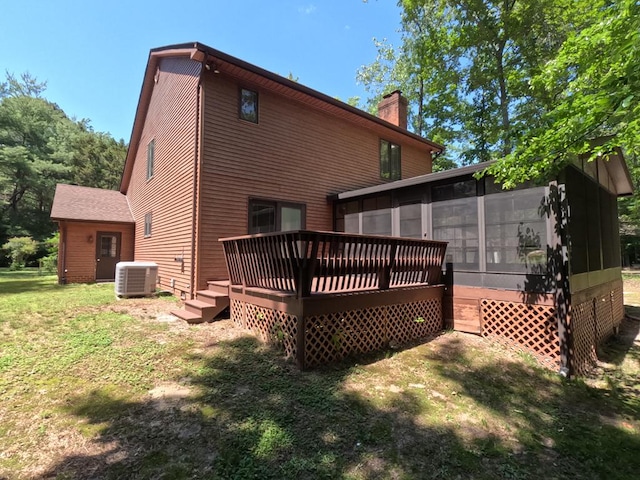 1113 Dillard St, Tappahannock, VA 22520 - rear view of house with a sunroom, a chimney, a wooden deck, a yard, and central AC unit
