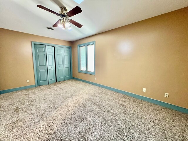 1113 Dillard St, Tappahannock, VA 22520 - unfurnished bedroom with baseboards, carpet floors, a closet, and a ceiling fan