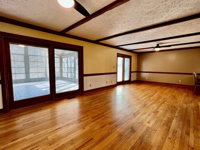 1113 Dillard St, Tappahannock, VA 22520 - spare room featuring ceiling fan, beamed ceiling, a textured ceiling, light wood-style floors, and baseboards