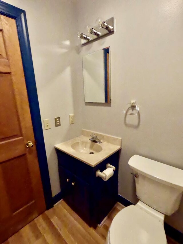 1113 Dillard St, Tappahannock, VA 22520 - half bathroom featuring vanity, wood finished floors, and toilet