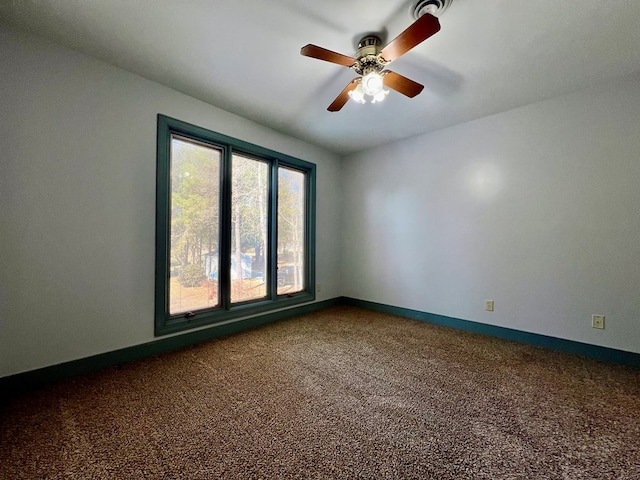 1113 Dillard St, Tappahannock, VA 22520 - unfurnished room featuring dark colored carpet, a ceiling fan, and baseboards