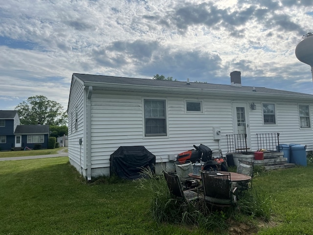 155 Rouzie Dr, Tappahannock, VA 22560 - back of property featuring a lawn and a chimney