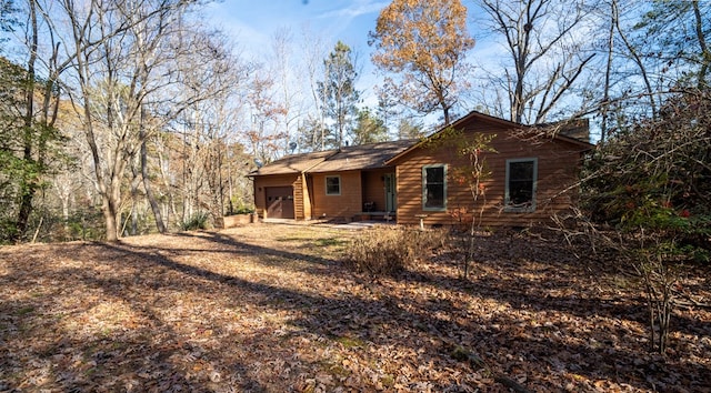 back of property featuring a garage