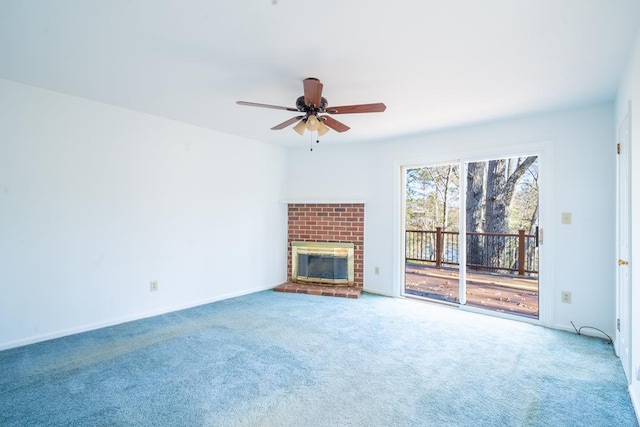 unfurnished living room with carpet flooring, a brick fireplace, and ceiling fan