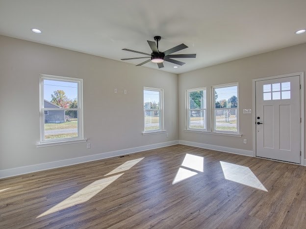 entrance foyer with ceiling fan and wood-type flooring