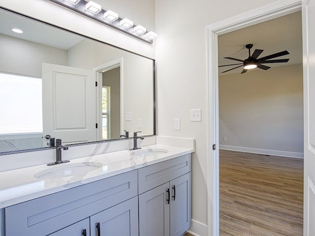 bathroom with hardwood / wood-style flooring, vanity, and ceiling fan