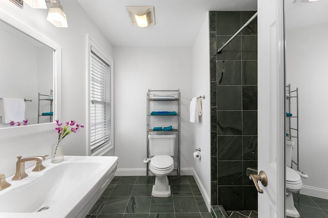 326 Chase St, Kilmarnock, VA 22482 - bathroom with toilet, baseboards, and marble look tile flooring