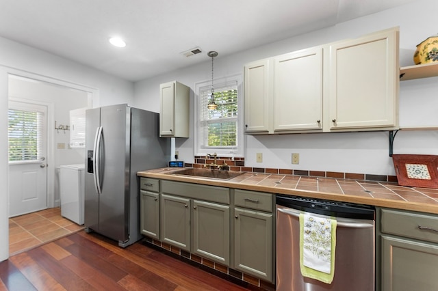 326 Chase St, Kilmarnock, VA 22482 - kitchen featuring appliances with stainless steel finishes, tile counters, open shelves, a sink, and pendant lighting