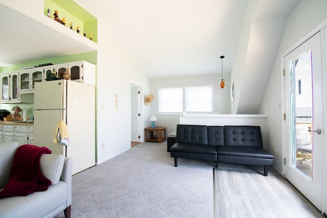 1150 Brammer Dr, Heathsville, VA 22473 - living area with vaulted ceiling, baseboards, and light colored carpet