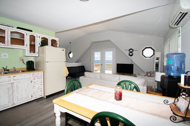 1150 Brammer Dr, Heathsville, VA 22473 - dining room with a wall mounted AC, dark wood-style floors, and vaulted ceiling
