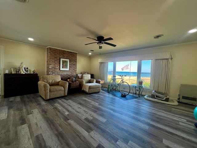 living area featuring visible vents, crown molding, and wood finished floors