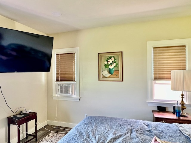 bedroom featuring dark hardwood / wood-style flooring and cooling unit