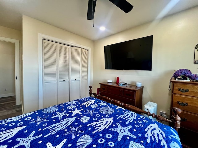 bedroom with a ceiling fan, a closet, and wood finished floors