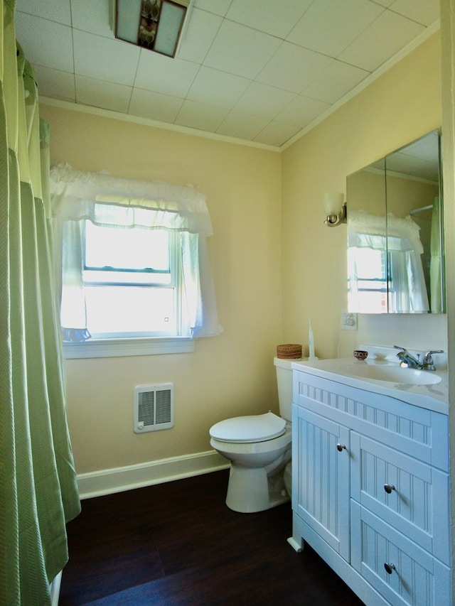 bathroom with hardwood / wood-style flooring, vanity, toilet, and crown molding