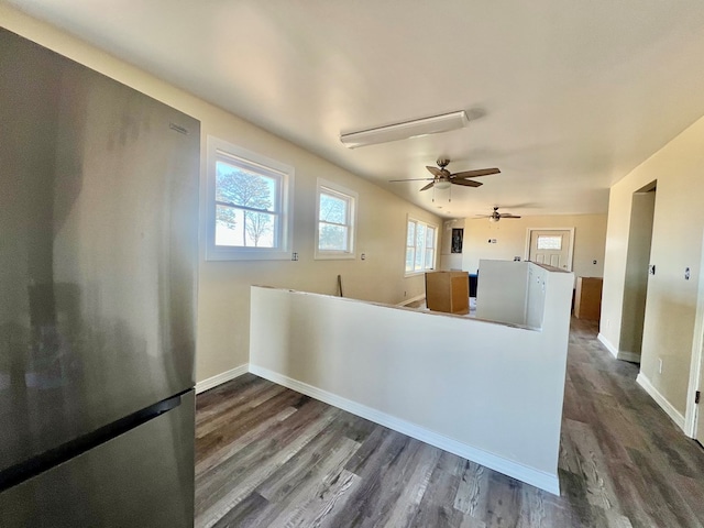 kitchen featuring dark wood finished floors, freestanding refrigerator, and baseboards