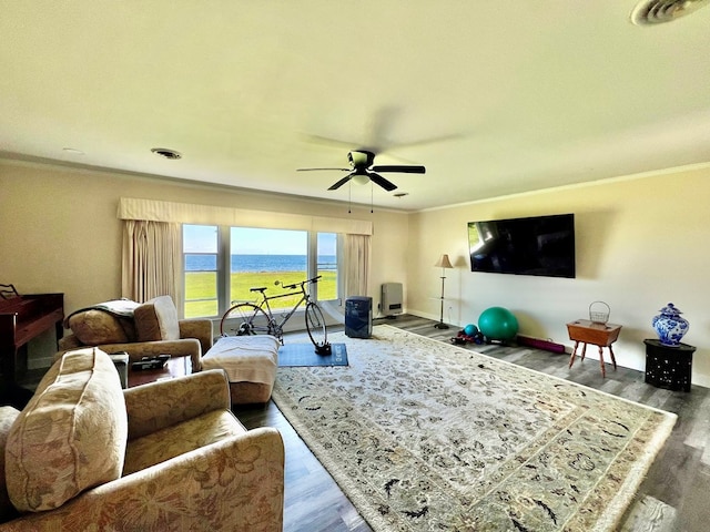 living room with ceiling fan, wood-type flooring, and ornamental molding