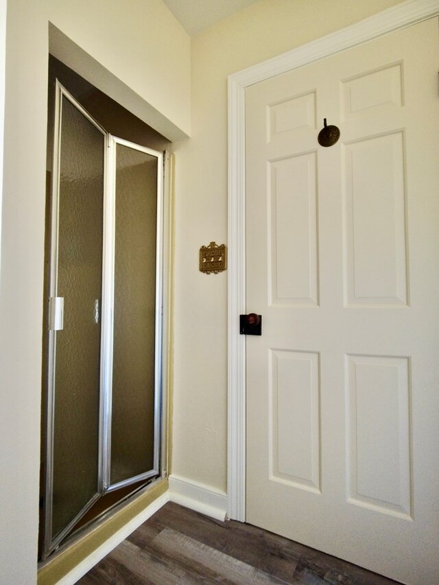 bathroom with a shower with door