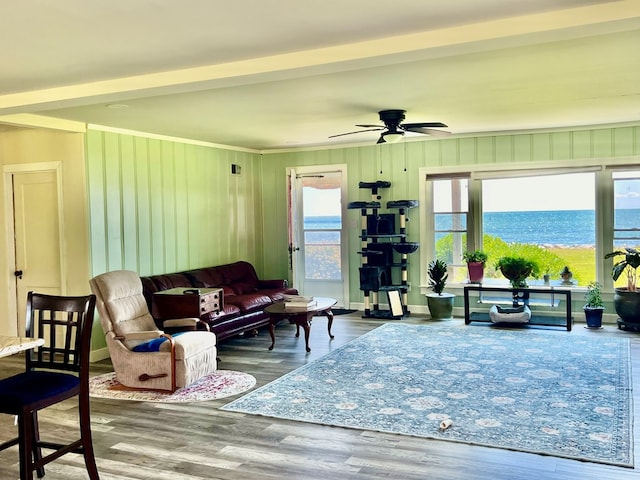 living room with a water view, ceiling fan, and hardwood / wood-style flooring