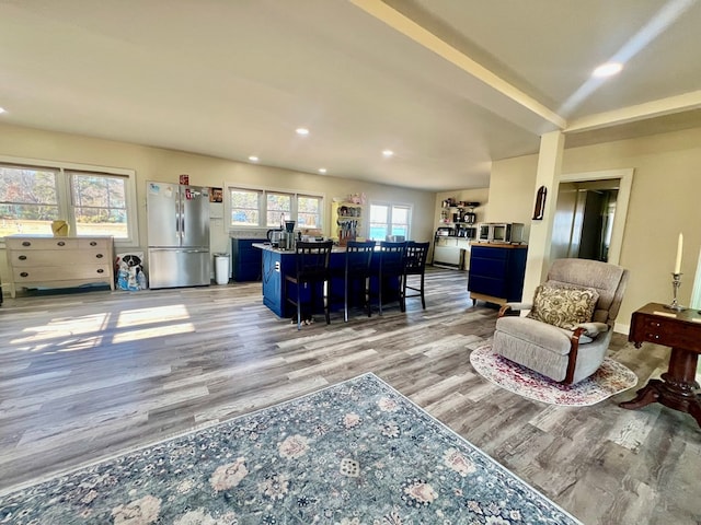 living area with recessed lighting and light wood finished floors