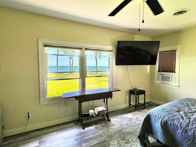 bedroom with ceiling fan, cooling unit, and light wood-type flooring