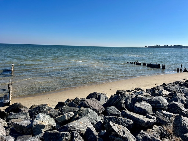 view of dock with a water view and a view of the beach