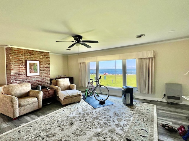 living area featuring a water view, crown molding, ceiling fan, and dark wood-type flooring