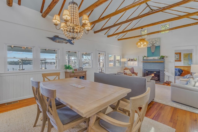 dining area featuring light wood-style flooring, visible vents, and an inviting chandelier