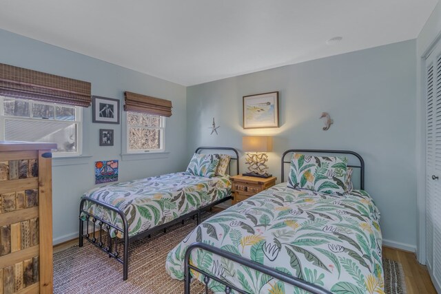 bedroom with baseboards and wood finished floors