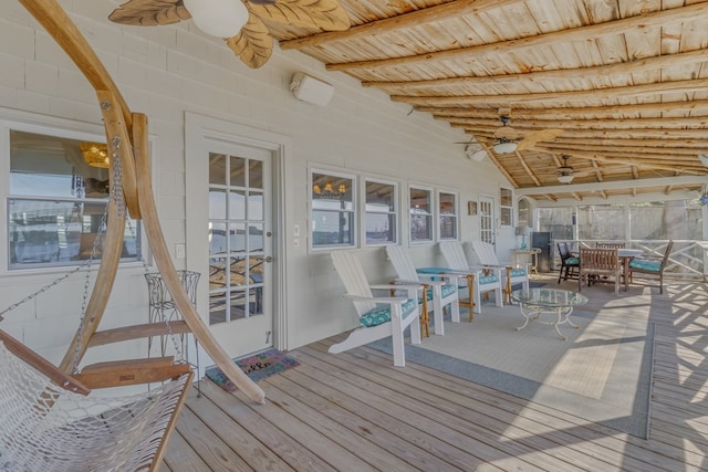 wooden deck with a ceiling fan and outdoor dining area