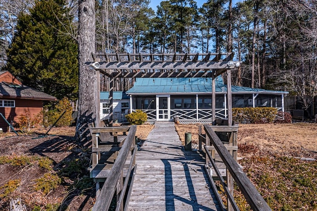 back of property with a sunroom