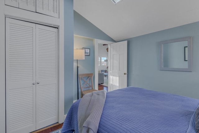 bedroom featuring vaulted ceiling, a closet, and wood finished floors