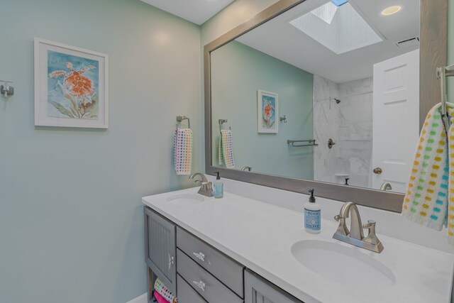 full bathroom with a shower, a skylight, a sink, and double vanity