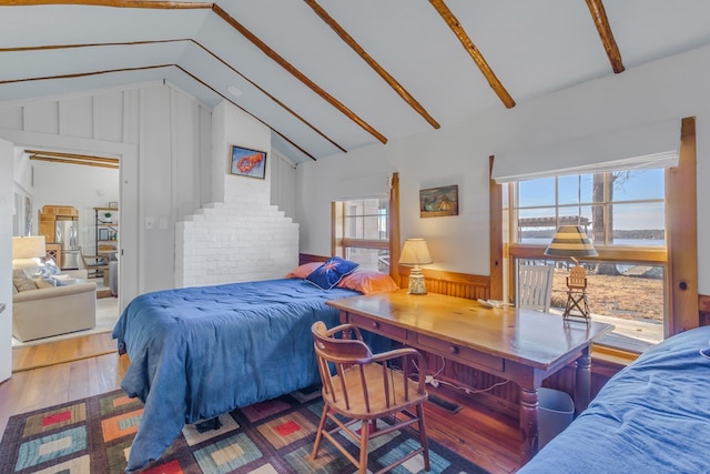 bedroom featuring lofted ceiling and wood finished floors