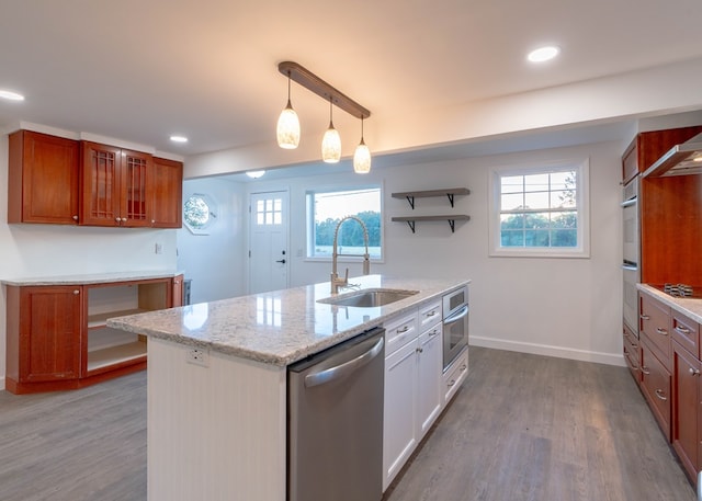 kitchen with light stone counters, stainless steel dishwasher, sink, hardwood / wood-style flooring, and white cabinetry