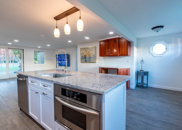 kitchen with decorative light fixtures, white cabinetry, dark wood-type flooring, and sink