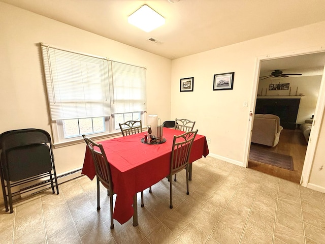 dining room with a baseboard radiator and ceiling fan