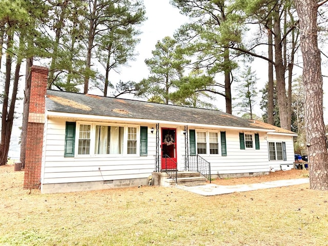 ranch-style home with a front lawn